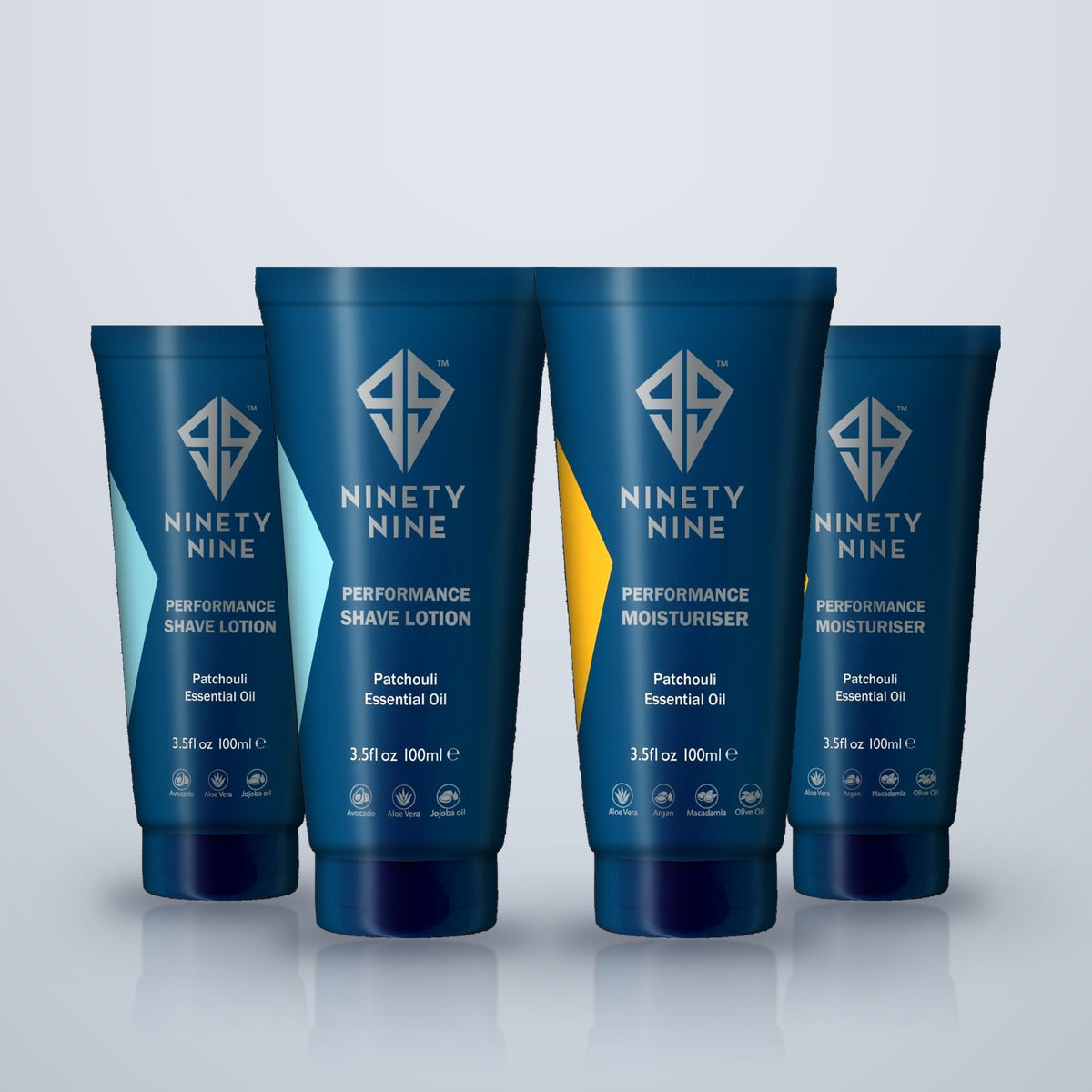 Four blue Ninety Nine personal care tubes standing upright on a light gray reflective surface. The tubes include Performance Shave Lotion, Performance Moisturiser, and two additional variants, all with white text and geometric logos.
