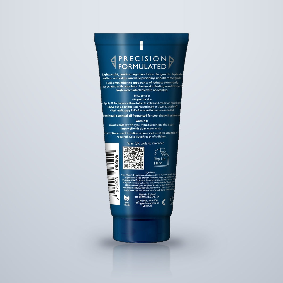 A dark blue cosmetic squeeze tube shown from the back on a light gray gradient background. The tube features white text reading 'PRECISION FORMULATED' and includes a barcode, QR code, and warning section.